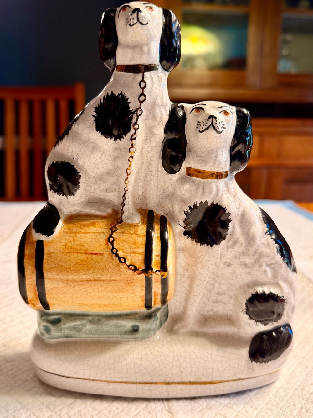Antique Staffordshire Two Spaniel Dogs one sitting on a barrel.